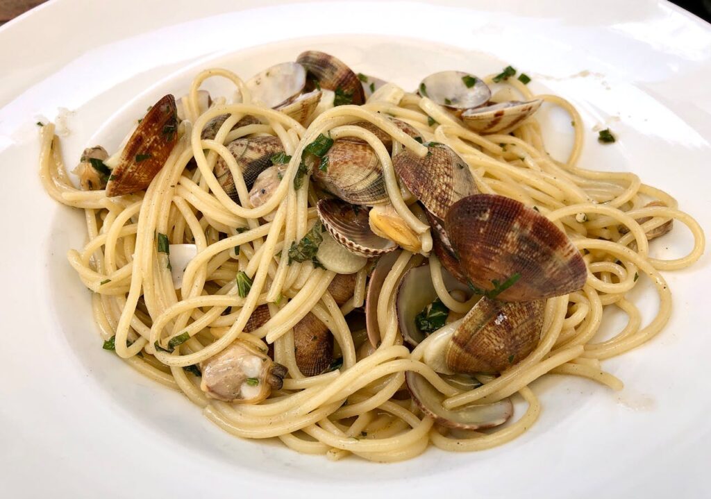 A gourmet plate of spaghetti alle vongole, showcasing fresh clams in a garlic sauce.